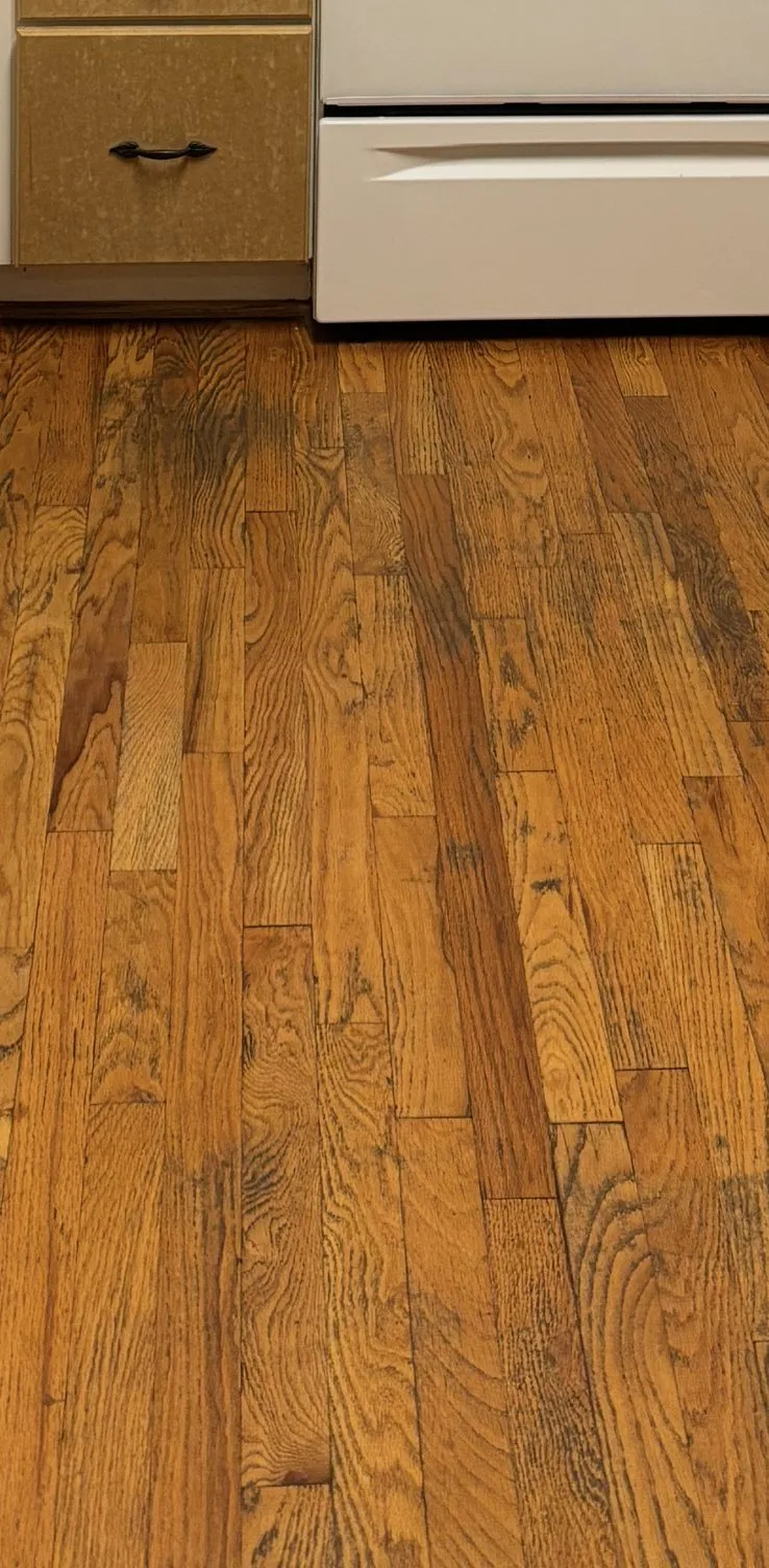 Before: close view of the worn, red-toned oak boards
